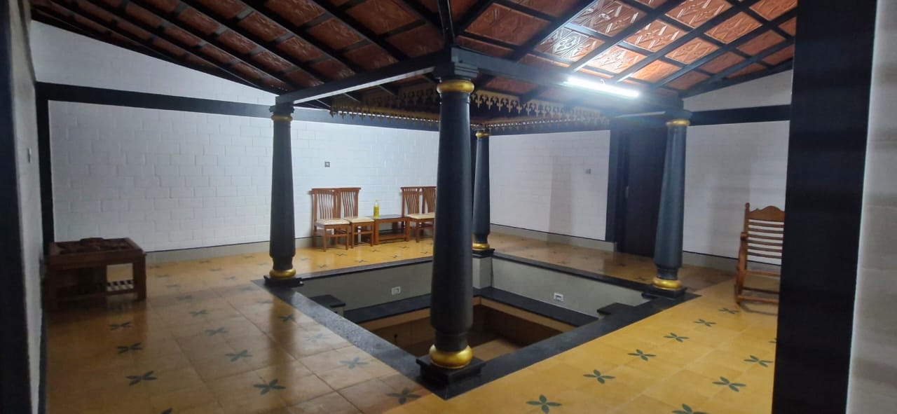 Small square room with tiled floor and light-colored brick walls. Located at Aqua Terra Villas - Belur, Sakleshpur
