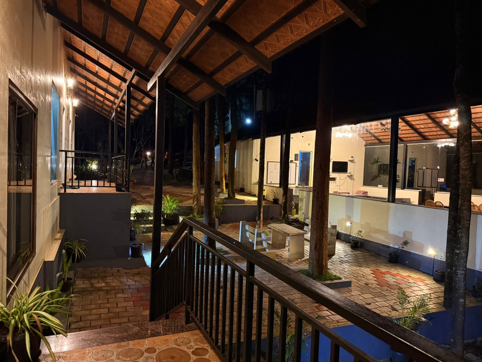 Small building with covered porch and pool at Janani Ecostay - Chikmagalur