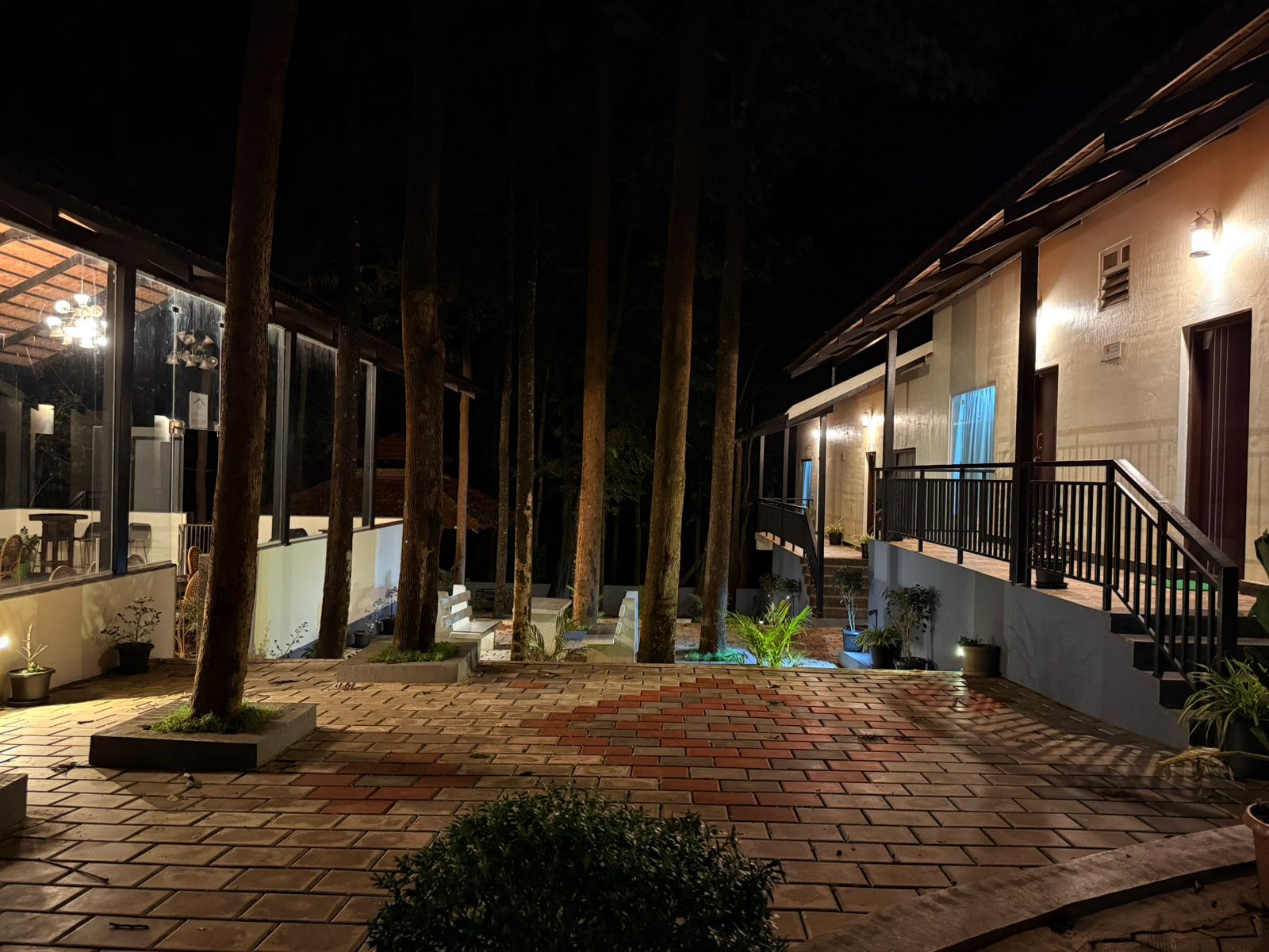 Brick patio with water feature and potted plants at Janani Ecostay - Chikmagalur